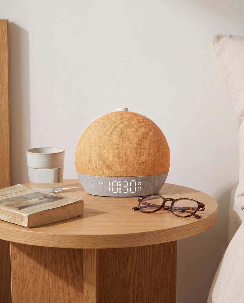 Easylight glowing softly on a bedside table beside a book at the end of the day